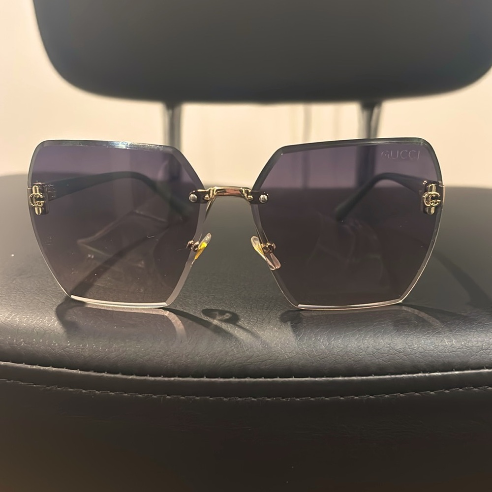 Signature arm sunglasses. Notice the details above on each lens.